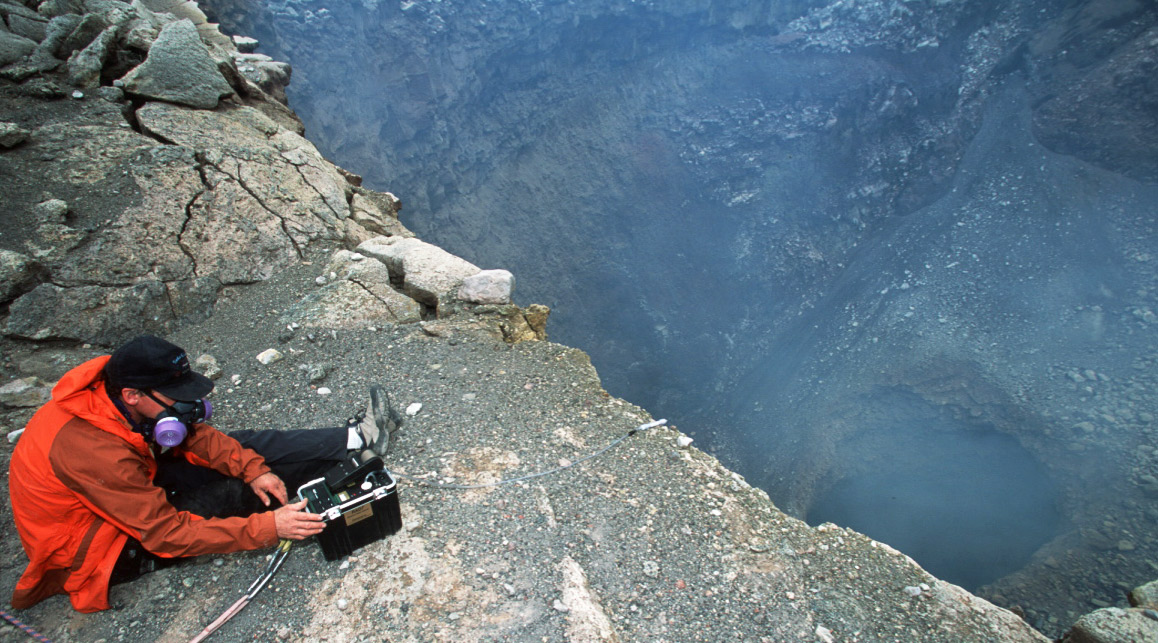 Geologist Kenneth Sims using a RAD7 on the rim of a volcano. Photo by John Catto.